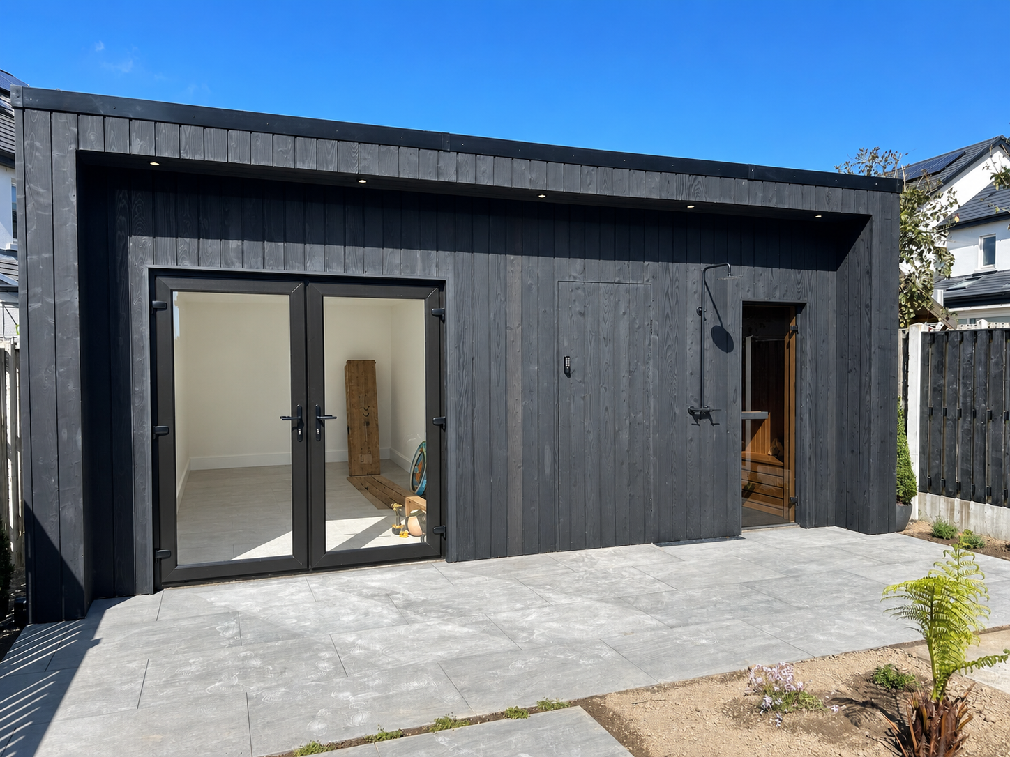 Black clad garden room with patio Dublin