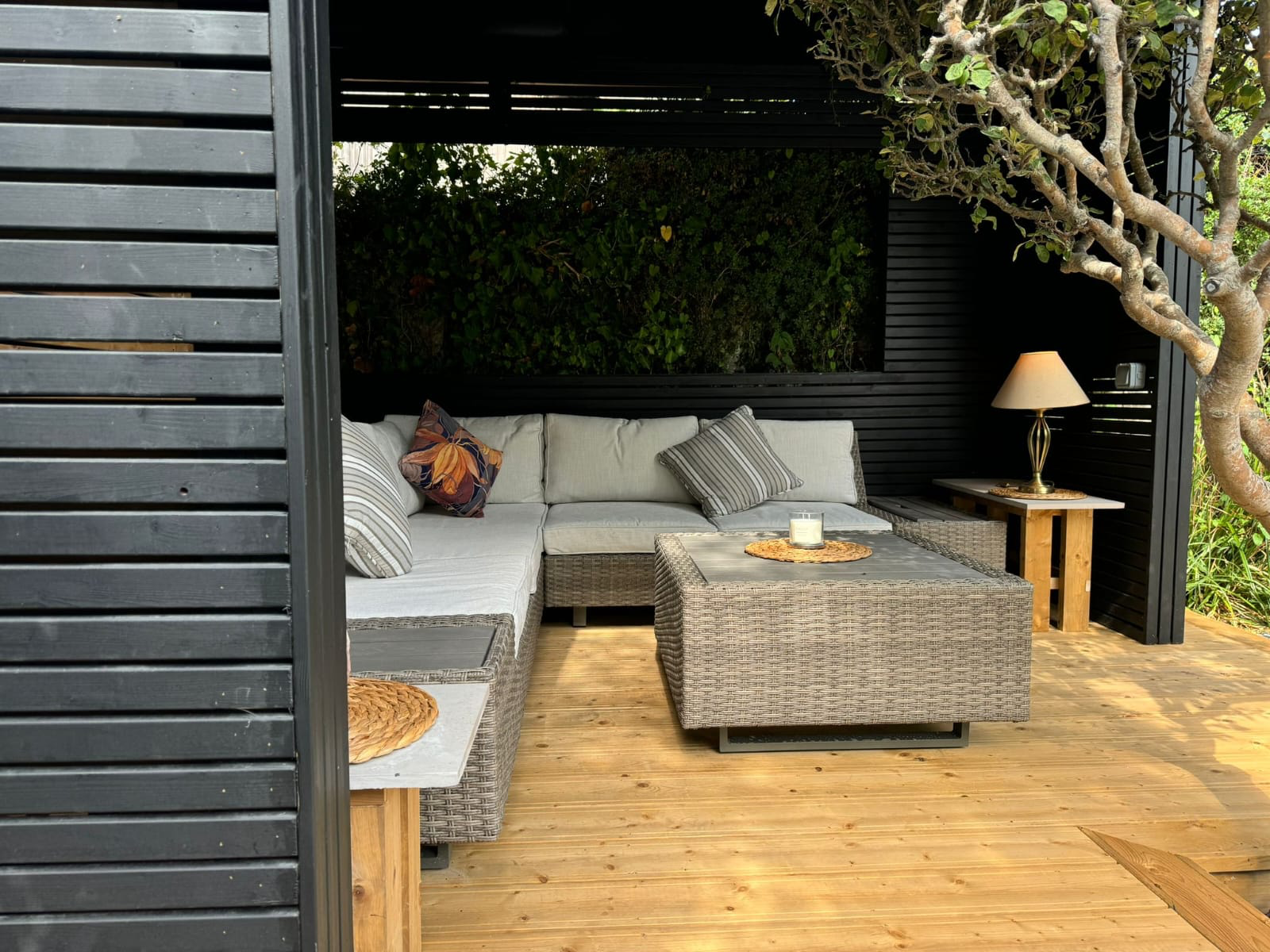 Black timber pergola with lounge seating and decking Dublin