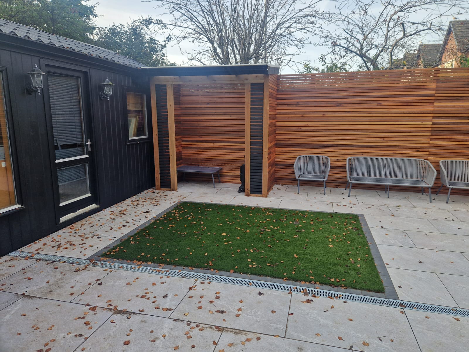 Patio with artificial grass inset and cedar pergola